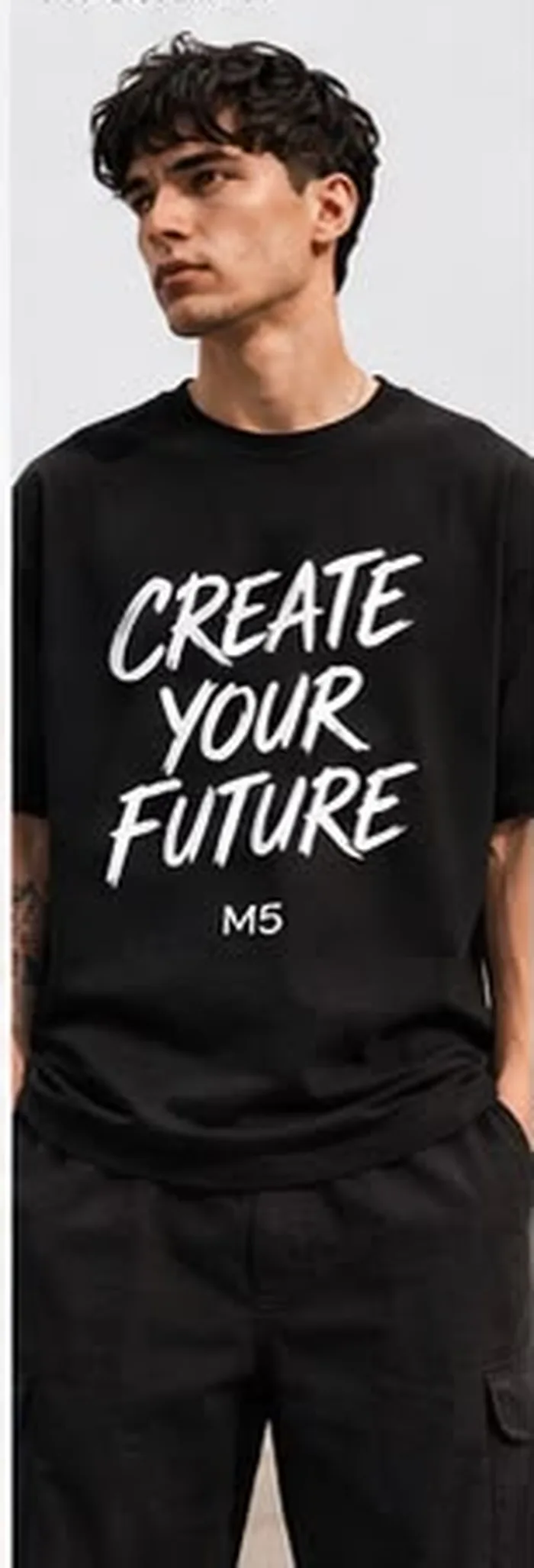 Model wearing a black M5 Outfit T-shirt printed with bold Create Your Future typography
