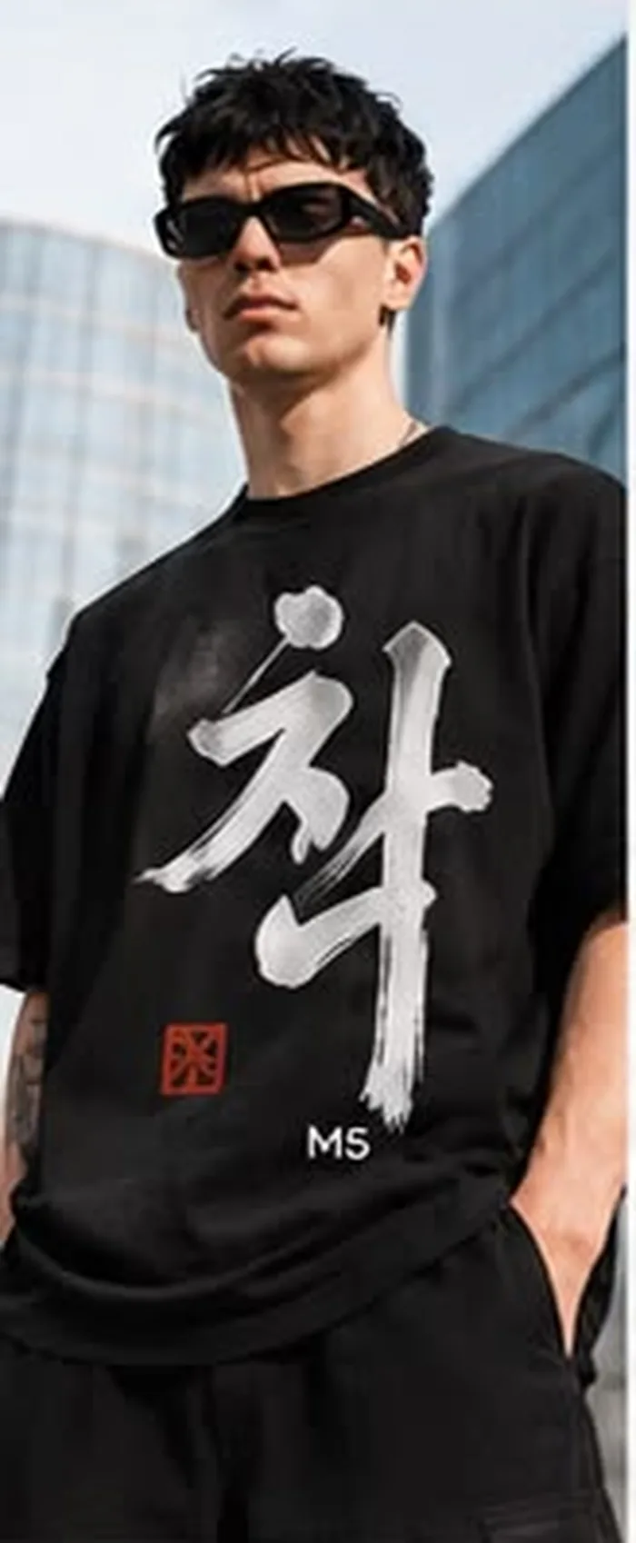 Model wearing a black M5 Outfit T-shirt printed with hand-lettered Korean calligraphy
