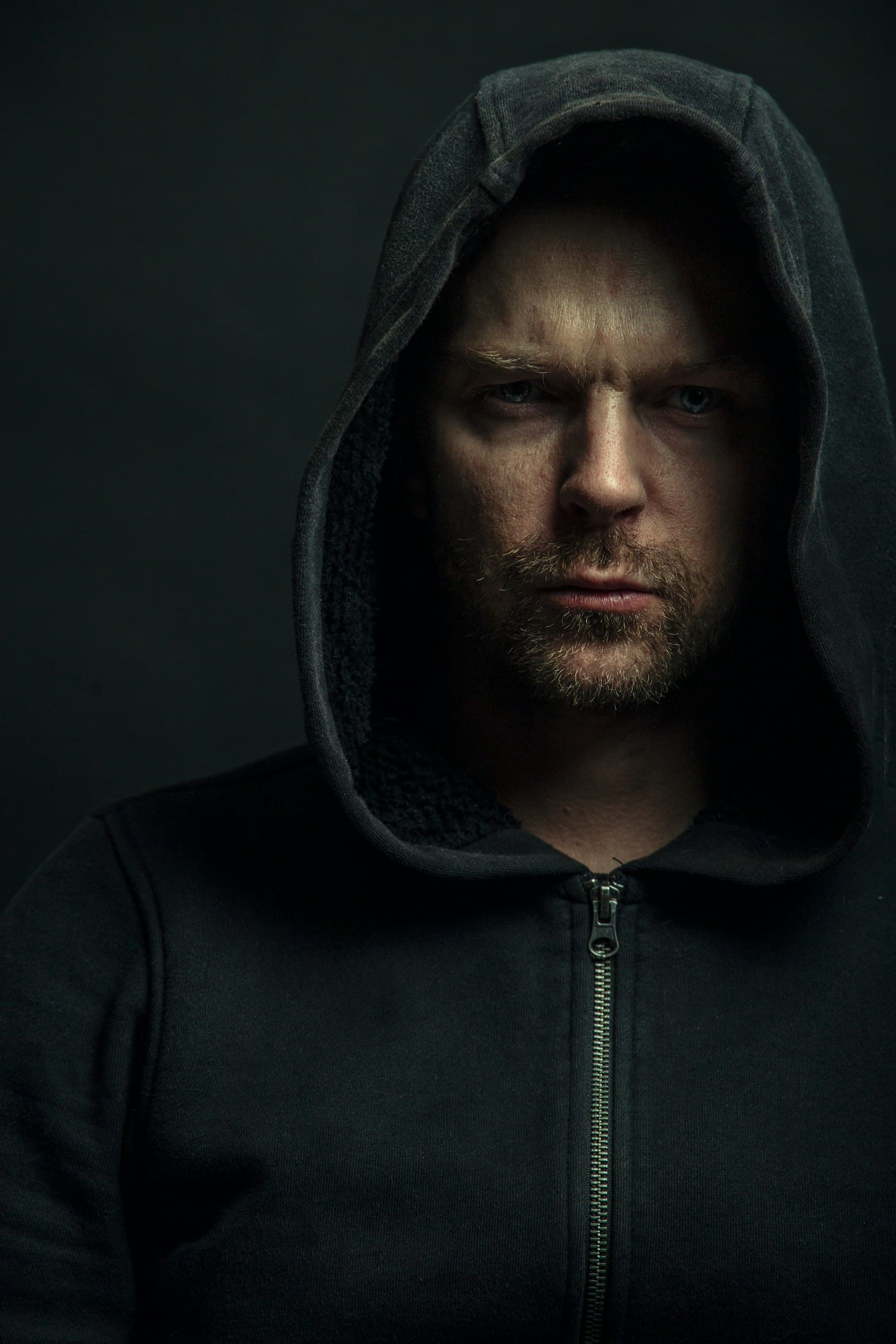 Model in a black M5 Outfit hoodie, studio portrait