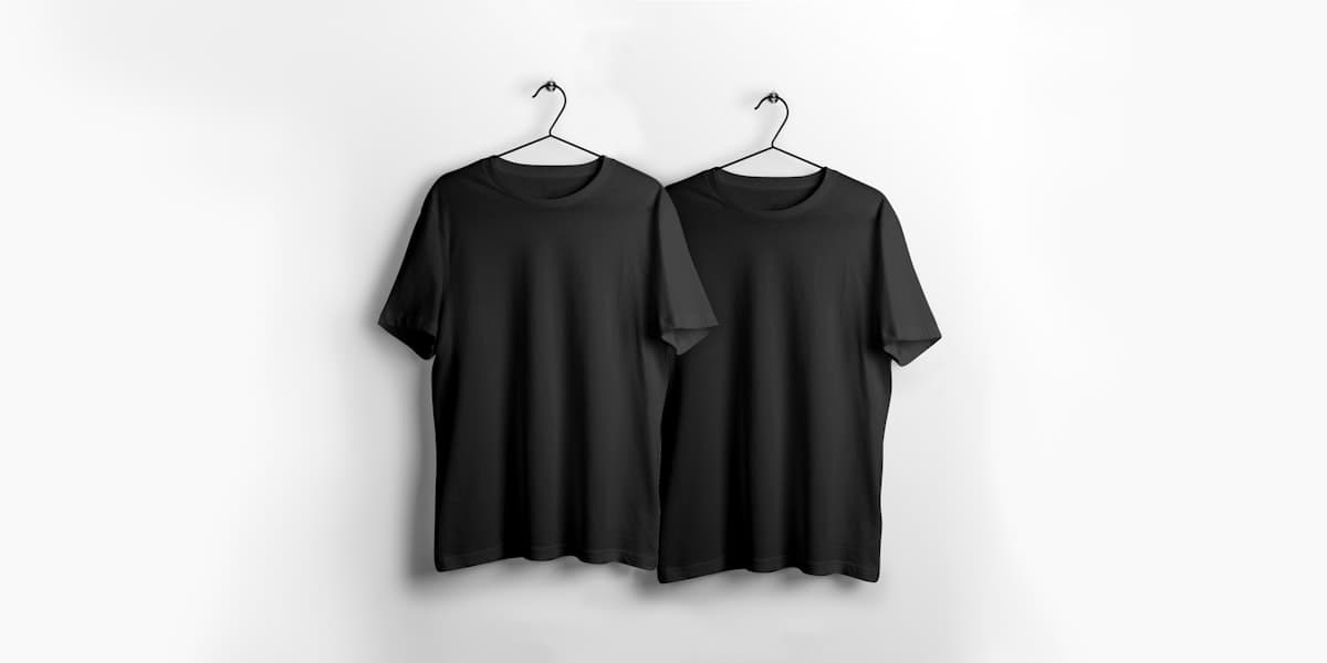 Two black cotton M5 Outfit tees on hangers against a white backdrop